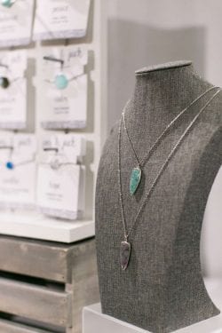 long silver necklaces with purple and green gemstone pendants